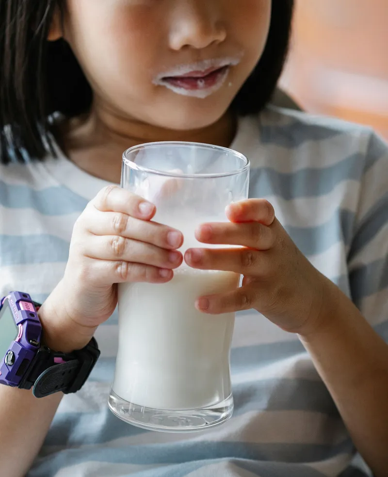 Child drinking a glass of milk